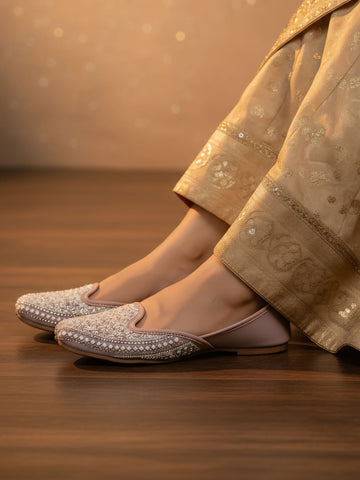 Model wearing pink embroidered traditional jutti with ethnic outfit