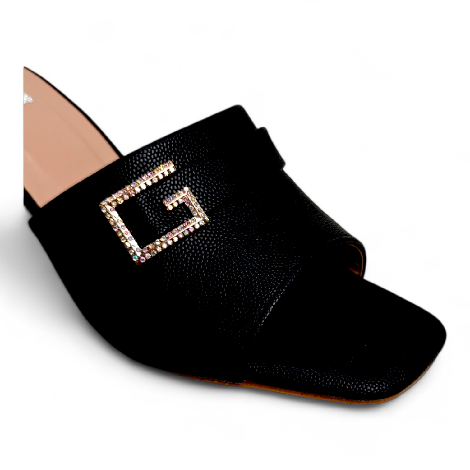 Close-up of G embellished buckle on black open toe footwear with transparent heel