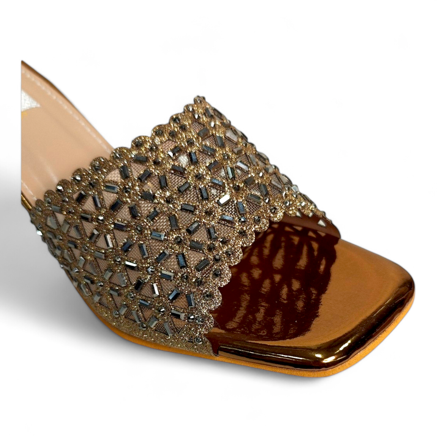 Close-up of triangle-shaped diamond embellishments on top of golden open toe heels