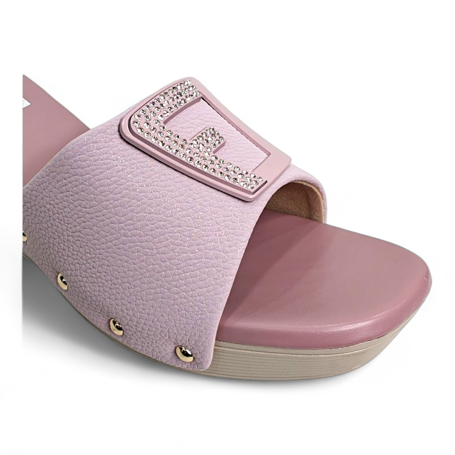 Close-up of the embellished buckle and wedge heel on pink open toe footwear