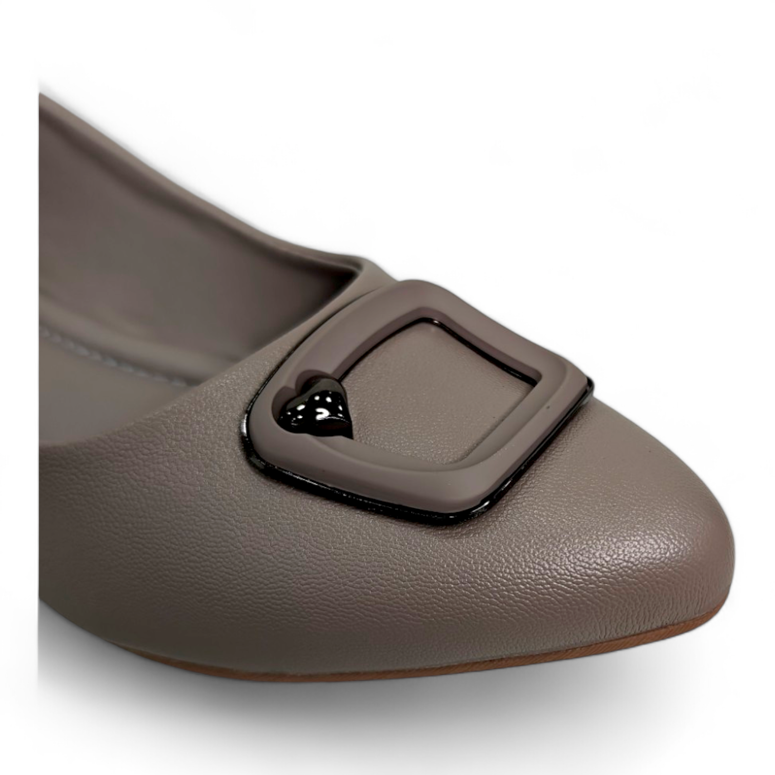 Close-up of square buckle detail on brown flat bellies made from soft material