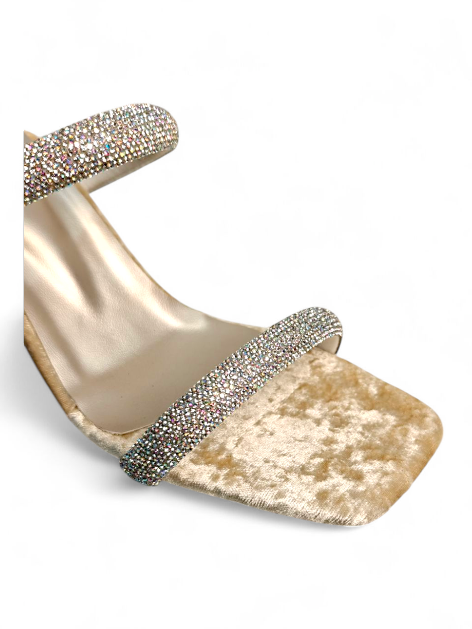Close-up of shimmering crystal straps and velvet footbed on gold heel sandals