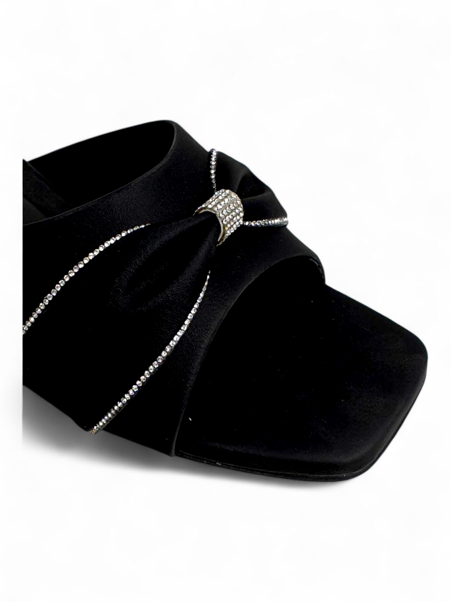 Close-up of knot strap with embellishment on black block heel sandals