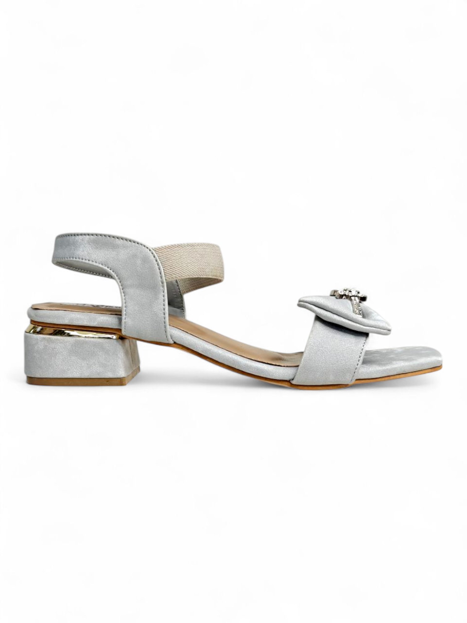 Side profile of silver low block heel sandals featuring a decorative bow