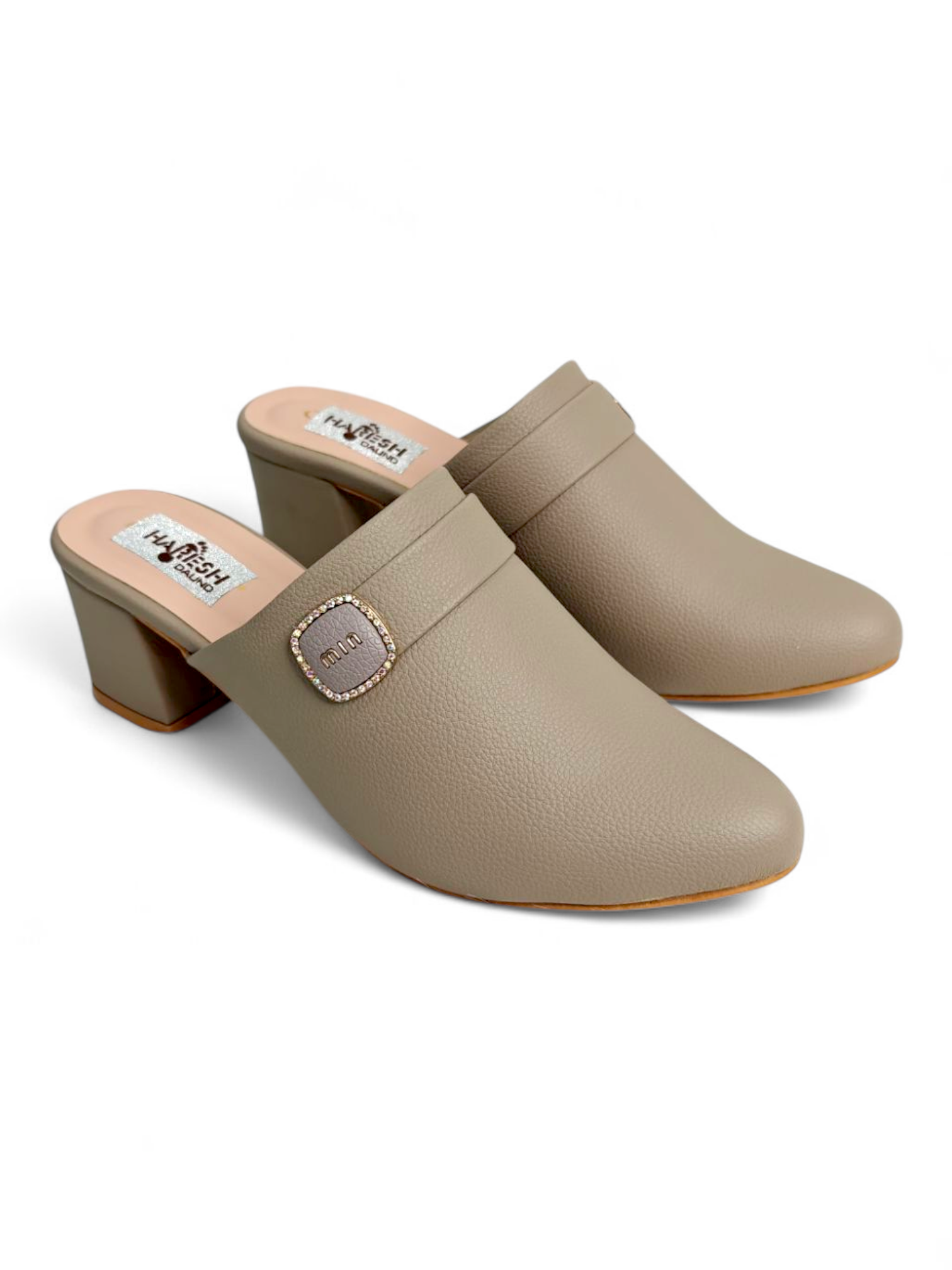 Top angle of taupe closed-toe mule heels showing buckle design
