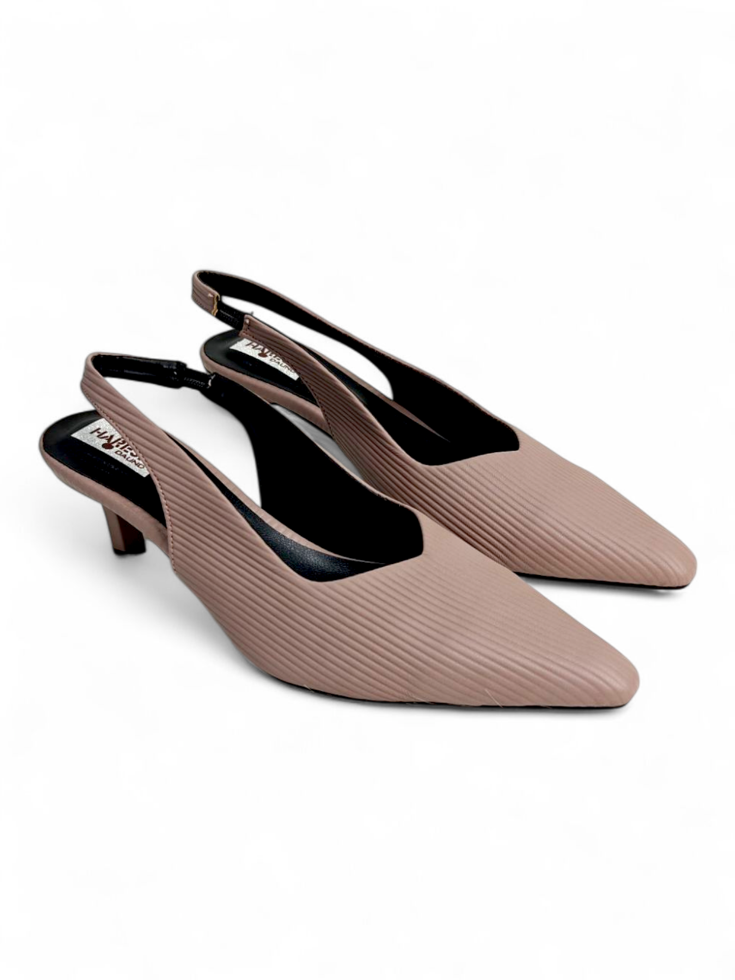 Top angle showing pointed-toe design and slingback strap on nude heels