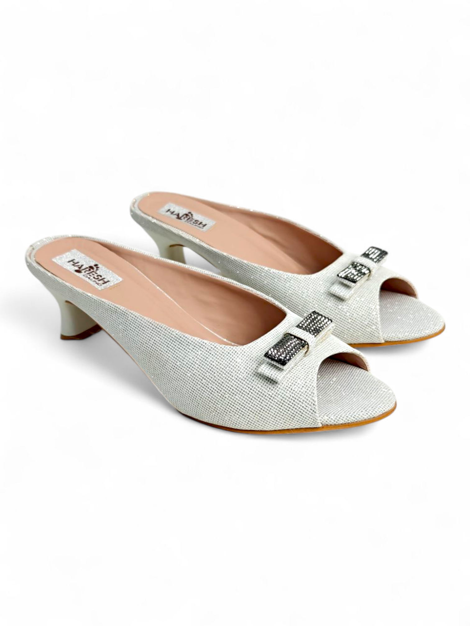 Top angle showing peep-toe and buckle detail on white textured kitten heels