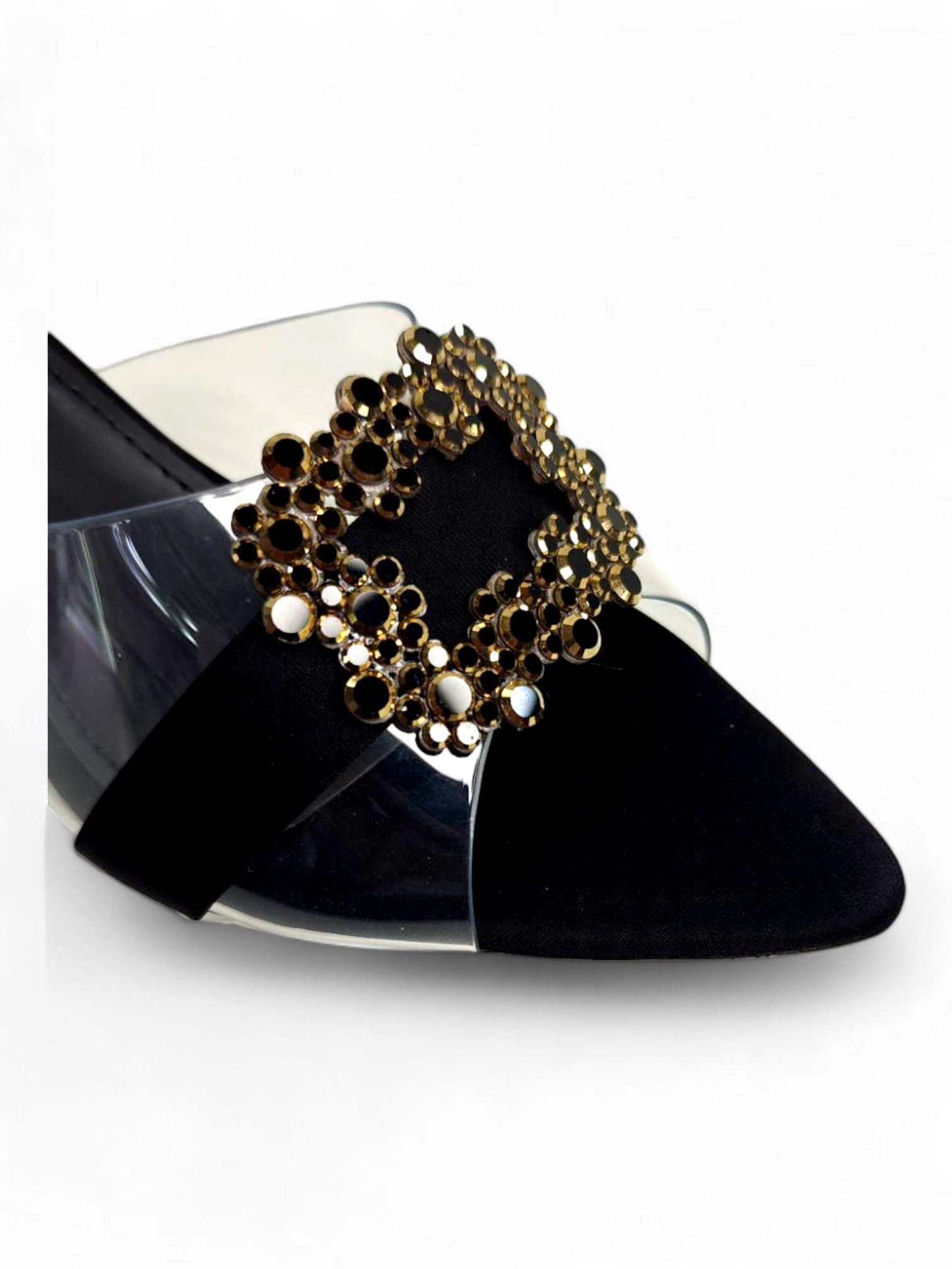 Top angle showing pointed toe and embellished buckle on black sandals