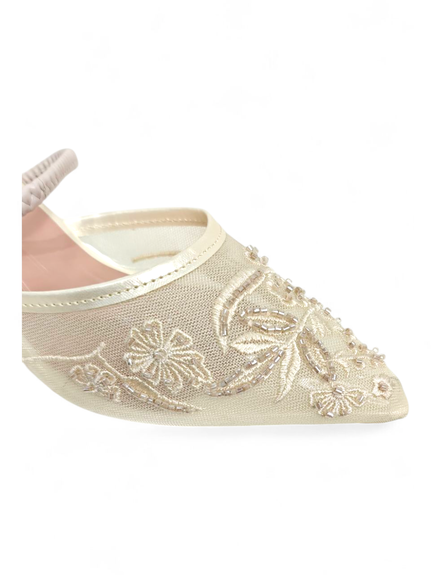 Close-up of floral embroidery and mesh detailing on cream mule heels