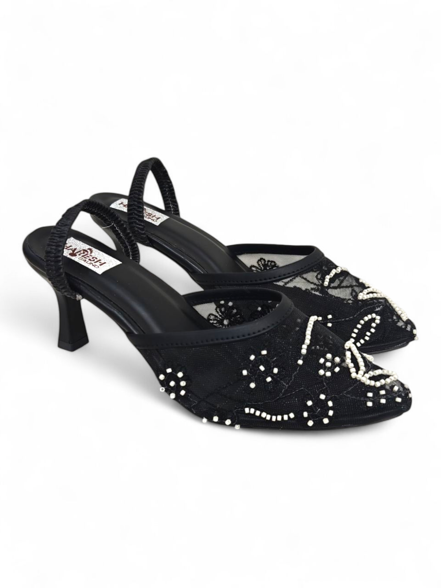 Top view showing embroidered mesh and pearl embellishments on black pointed-toe heels