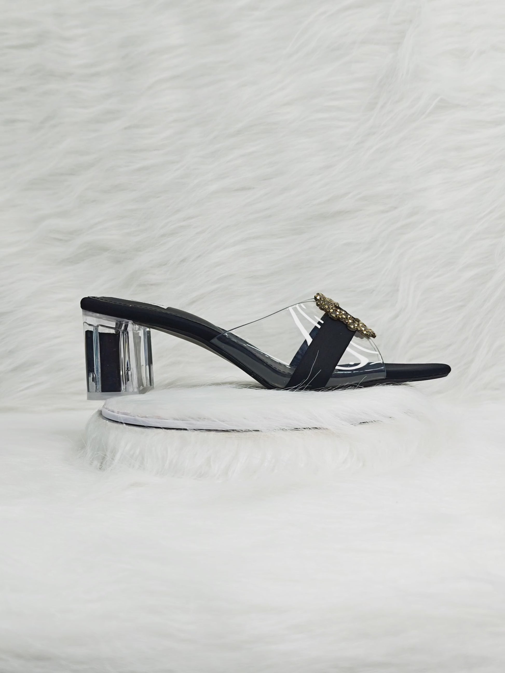 360 degree rotation of black transparent strap sandals with gold embellished buckle and clear block heel
