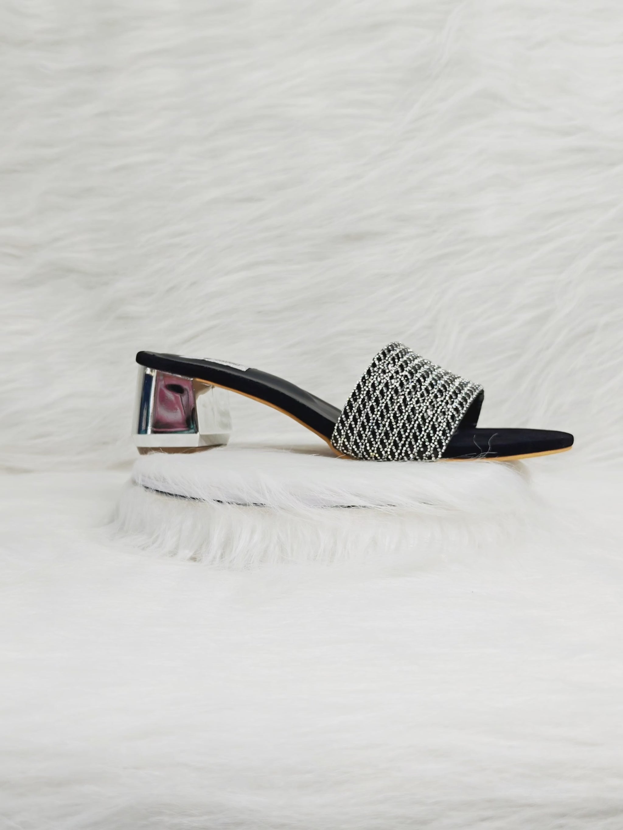 A 360° view of black and silver embellished block heel sandals for women, highlighting the crystal-studded strap, cushioned insole, and transparent block heel. Ideal for festive, party, and evening wear looks.