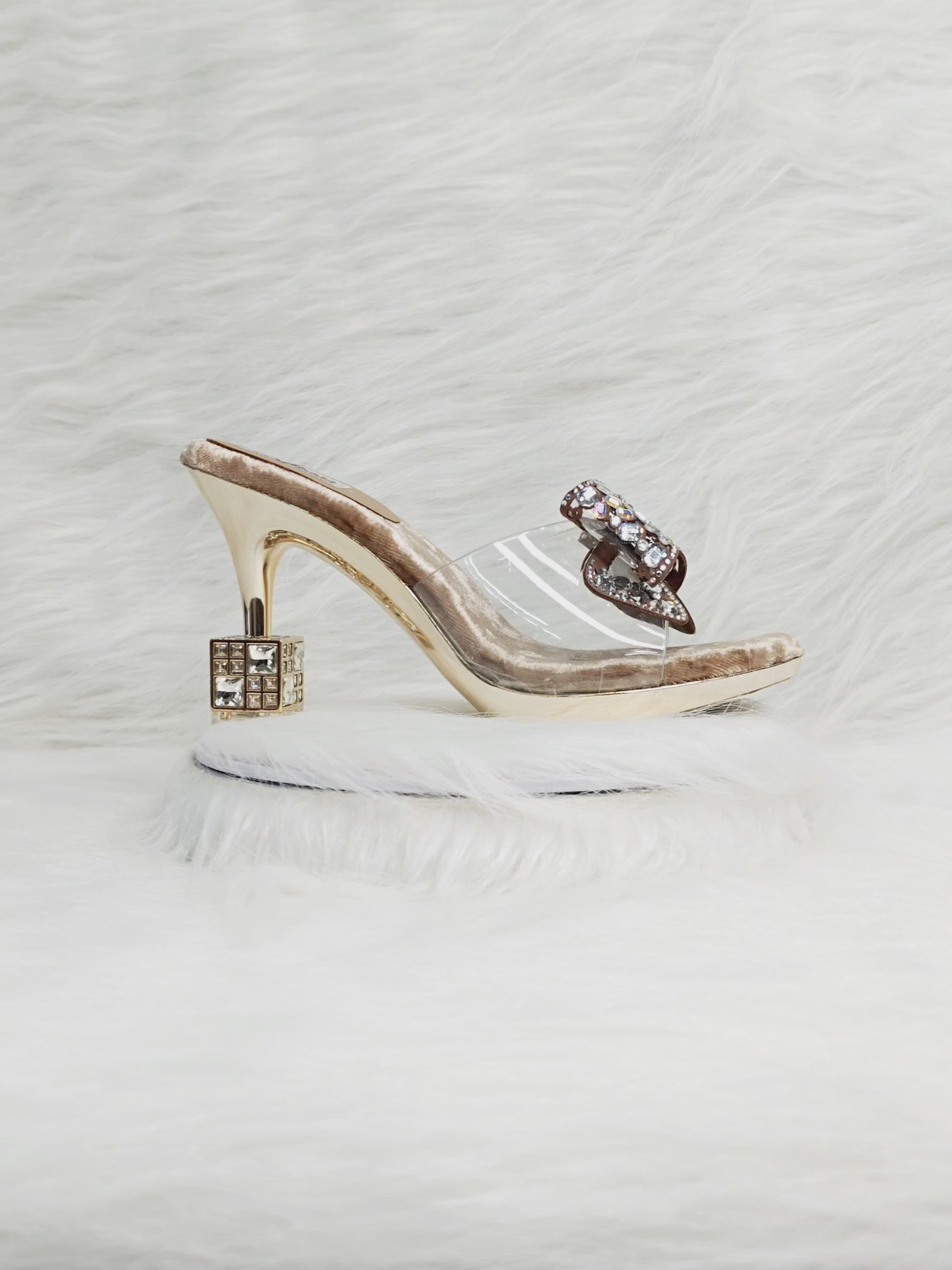 360 degree rotation of gold velvet heels with embellished bow, transparent strap, and designer cube heel for women