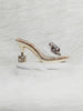 360 degree rotation of gold velvet heels with embellished bow, transparent strap, and designer cube heel for women