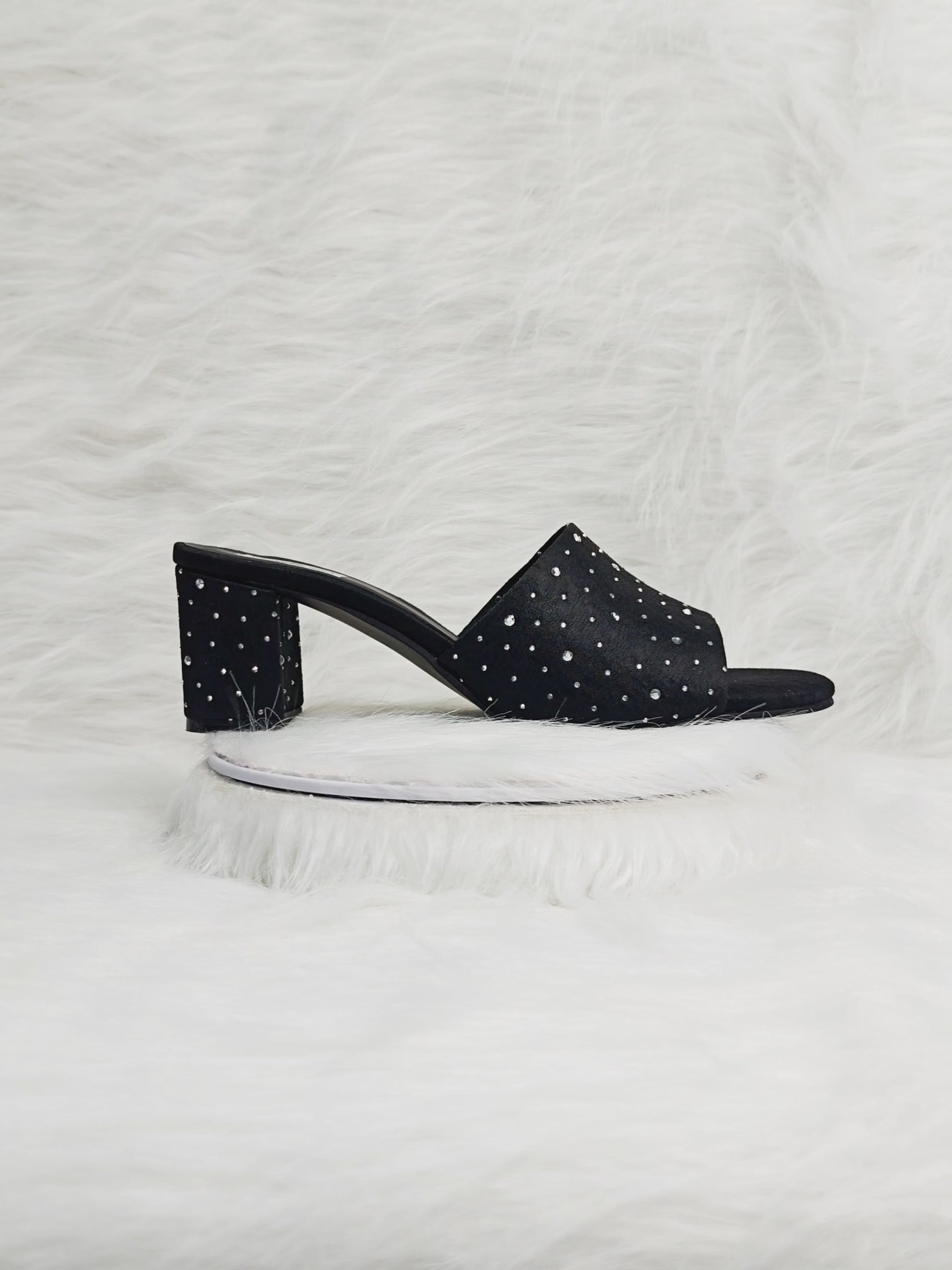 360° view of black embellished block heel sandals for women, featuring crystal-studded detailing, a soft suede finish, and comfortable mid-block heels. Ideal for festive, wedding, and evening wear.