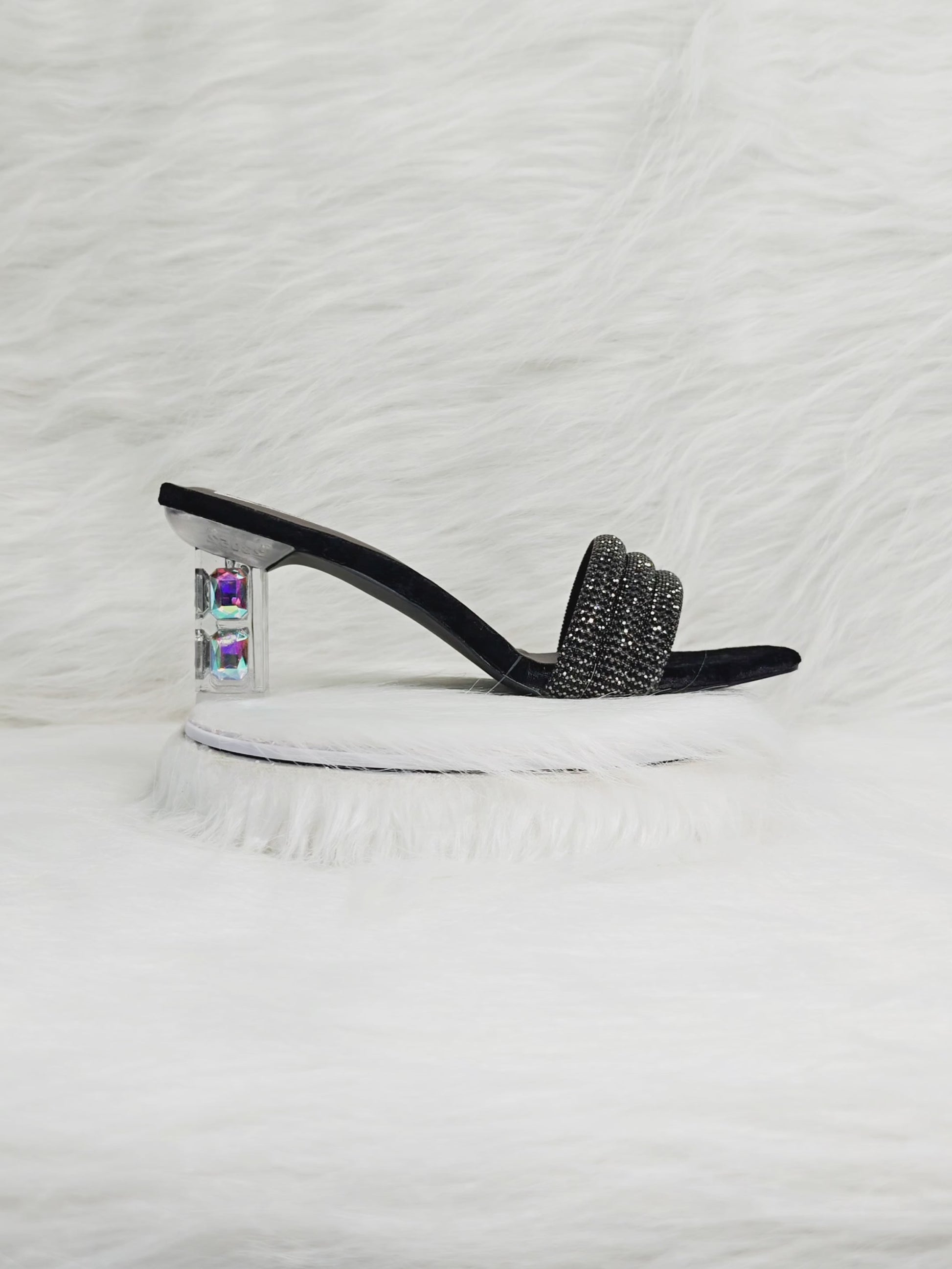 Video showing a model walking in black embellished block heels with transparent heel — close-ups of sparkle, cushioned comfort, and heel detailing for festive wear.