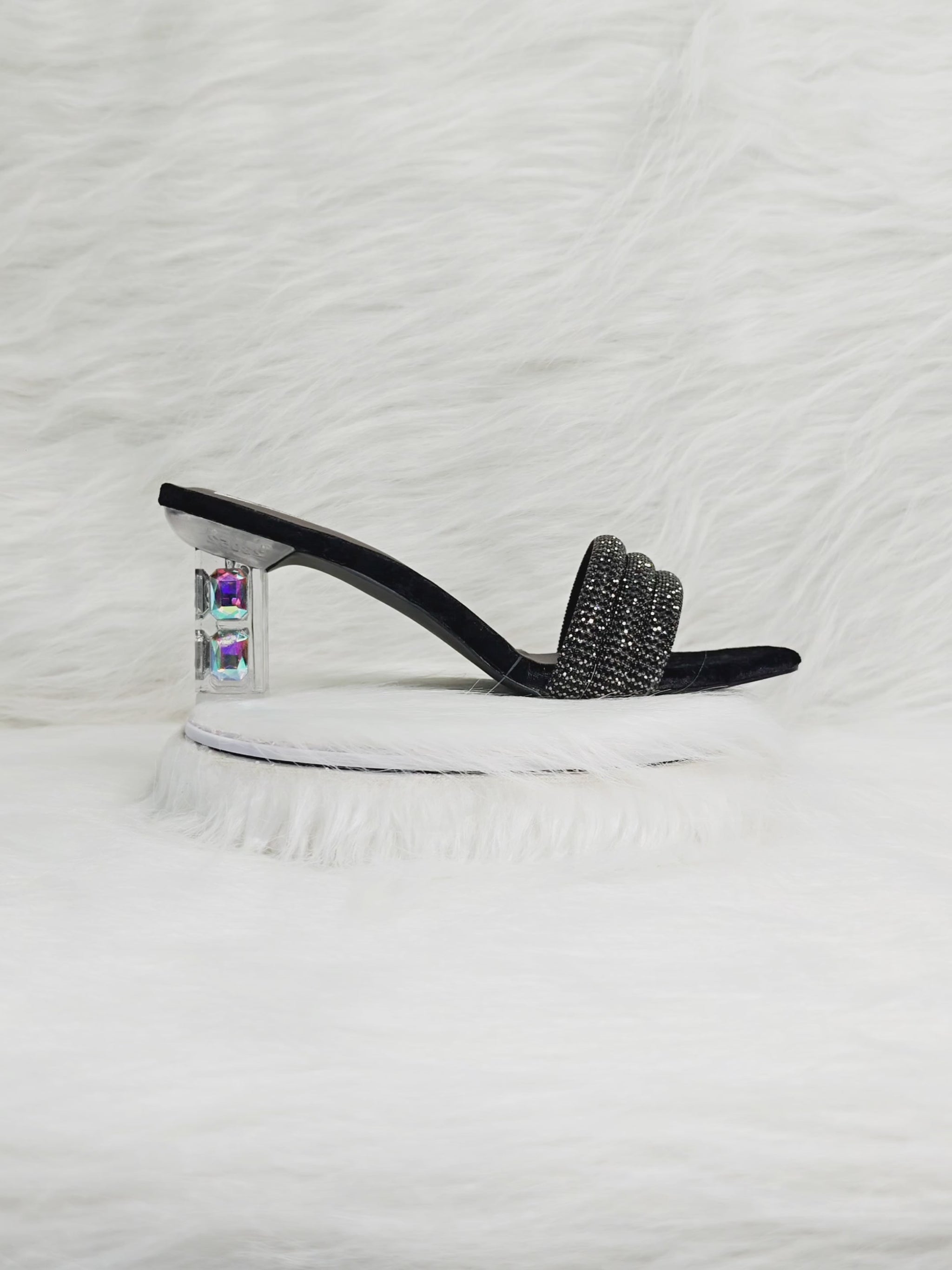 Video showing a model walking in black embellished block heels with transparent heel — close-ups of sparkle, cushioned comfort, and heel detailing for festive wear.