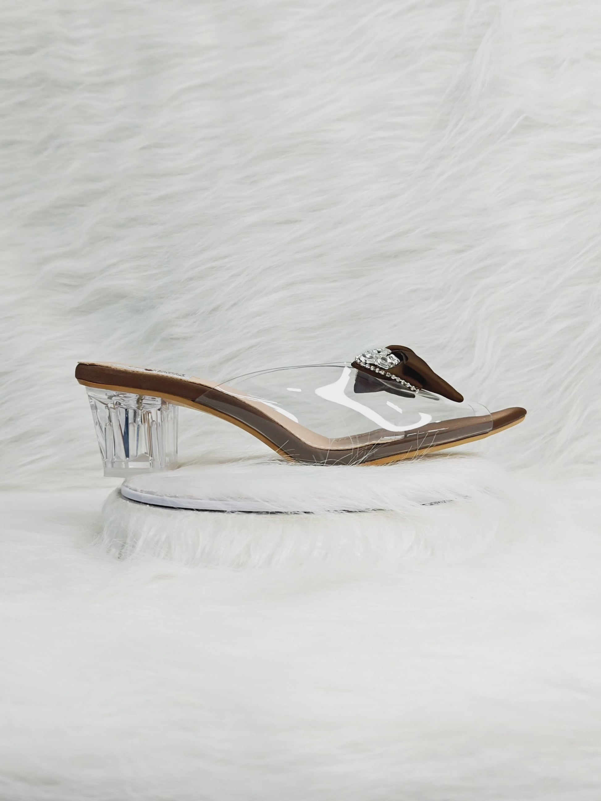 360 degree rotation of brown bow embellished transparent strap wedge heel sandals for women