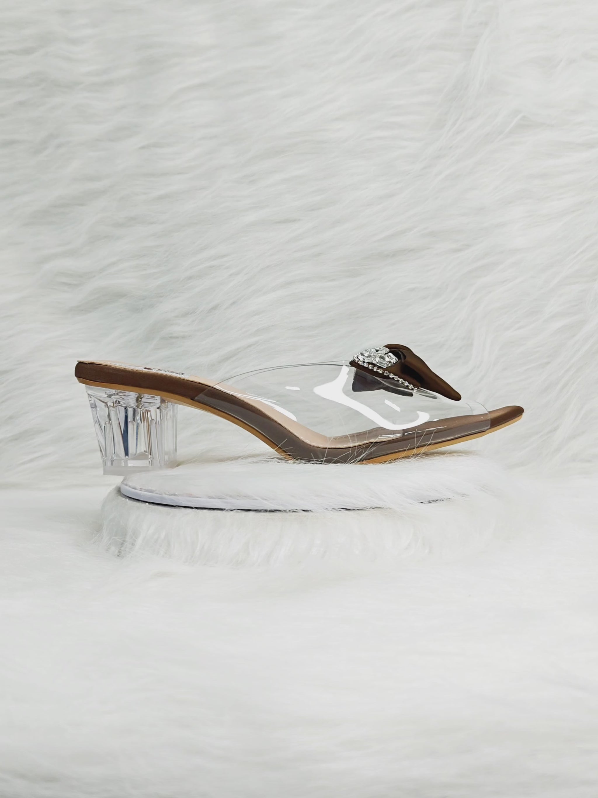 360 degree rotation of brown bow embellished transparent strap wedge heel sandals for women
